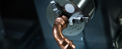 Copper plumbing part in dot-peen rotary device for impact marking machine