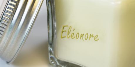 Engraving on candle glass filled with gold gilding wax